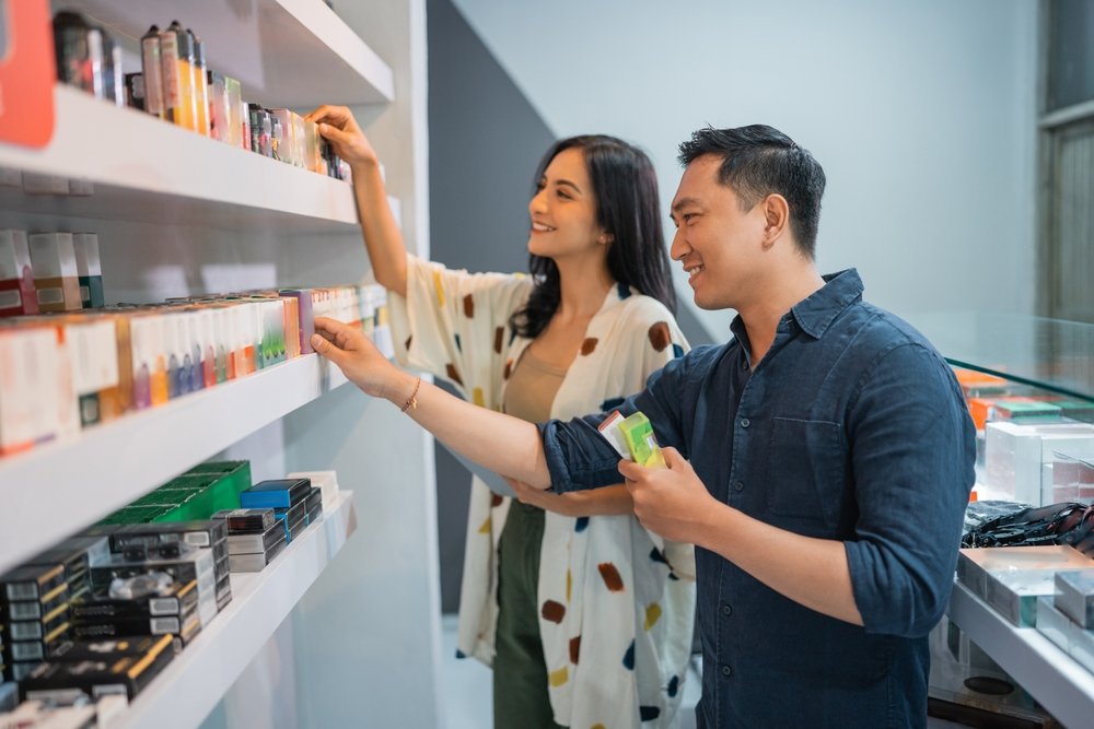 couple,of,vape,seller,observing,the,liquid,from,the,shelf